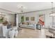 Open-concept space features hardwood floors, a modern chandelier, and seamless access to the dining area at 3835 Hickory Branch Trl, Suwanee, GA 30024