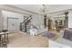 Open concept living area features hardwood floors, a modern chandelier and staircase at 3835 Hickory Branch Trl, Suwanee, GA 30024