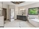 Bright bathroom featuring a double vanity, soaking tub, and a tiled shower at 3835 Hickory Branch Trl, Suwanee, GA 30024