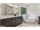 Bright main bathroom with a large vanity, a soaking tub, and a neutral color palette at 3835 Hickory Branch Trl, Suwanee, GA 30024