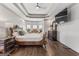Comfortable main bedroom with stylish decor, TV, bay window and a dark wood floor at 3835 Hickory Branch Trl, Suwanee, GA 30024