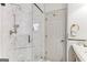 Elegant shower with glass enclosure, overhead and handheld shower heads, and built-in niche at 3835 Hickory Branch Trl, Suwanee, GA 30024