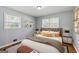 Staged bedroom offers natural light, hardwood floors, and modern furnishings at 4653 Ridgewood Dr, Forest Park, GA 30297