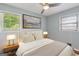 Staged bedroom with hardwood floors, natural light, and modern lighting fixtures at 4653 Ridgewood Dr, Forest Park, GA 30297