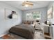 Staged bedroom boasts hardwood floors, ceiling fan, natural light, and a desk at 4653 Ridgewood Dr, Forest Park, GA 30297