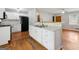 Open kitchen with white cabinets, granite countertops, and view of the living area at 4653 Ridgewood Dr, Forest Park, GA 30297