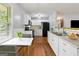 Updated kitchen features white cabinets, granite countertops, and stainless steel sink at 4653 Ridgewood Dr, Forest Park, GA 30297