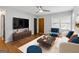 Staged living room featuring hardwood floors, neutral paint, a ceiling fan, and stylish furniture at 4653 Ridgewood Dr, Forest Park, GA 30297