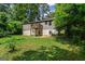 Backyard exterior view showing deck and a brick house with mature trees at 2835 Laguna Dr, Decatur, GA 30032