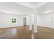 Spacious basement featuring wood-look floors, white columns, and ample natural light at 2835 Laguna Dr, Decatur, GA 30032