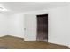 Unfinished basement area, featuring a door, with wood look flooring at 2835 Laguna Dr, Decatur, GA 30032