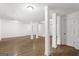 Basement with white walls, wood-look flooring, and support columns throughout space at 2835 Laguna Dr, Decatur, GA 30032