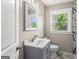 Bathroom featuring a sleek vanity, marble-tiled shower, and a bright window view at 2835 Laguna Dr, Decatur, GA 30032