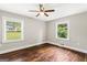 Bedroom featuring hardwood floors, two windows, ceiling fan, and neutral paint at 2835 Laguna Dr, Decatur, GA 30032