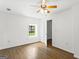 Sunlit bedroom showcasing wood-look floors, a ceiling fan, and neutral walls at 2835 Laguna Dr, Decatur, GA 30032