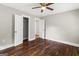 Bedroom with hardwood floors, closet, and entry door with neutral color palette at 2835 Laguna Dr, Decatur, GA 30032