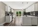 Modern kitchen with white cabinets, black backsplash, and stainless steel appliances at 2835 Laguna Dr, Decatur, GA 30032