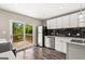 Updated kitchen with stainless steel appliances, a view to the outside deck, and modern finishes at 2835 Laguna Dr, Decatur, GA 30032