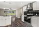 Modern kitchen featuring white cabinets, stainless steel appliances, and dark subway tile backsplash at 2835 Laguna Dr, Decatur, GA 30032
