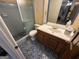 Full bathroom featuring patterned flooring, glass shower door, and a traditional vanity at 4540 Lindsey Dr, Powder Springs, GA 30127