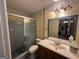 Bathroom with a glass-enclosed shower, floral wallpaper, and vanity at 4540 Lindsey Dr, Powder Springs, GA 30127
