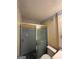 Bathroom showcasing a glass shower, toilet, and floral wallpaper at 4540 Lindsey Dr, Powder Springs, GA 30127