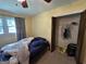 Cozy bedroom featuring a window view and closet with bi-fold doors at 4540 Lindsey Dr, Powder Springs, GA 30127