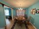 Elegant dining room with classic chandelier and seating for six at 4540 Lindsey Dr, Powder Springs, GA 30127