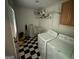 Functional laundry room with washer, dryer and ample storage at 4540 Lindsey Dr, Powder Springs, GA 30127