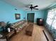 Inviting living room featuring light blue walls, ceiling fan, and beautiful natural light at 4540 Lindsey Dr, Powder Springs, GA 30127