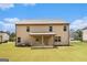 Back exterior of a home with a covered porch at 8041 Louis Dr, Locust Grove, GA 30248