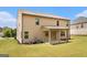 Back exterior view of a two story home with covered porch at 8041 Louis Dr, Locust Grove, GA 30248