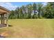 Large backyard with green grass and mature trees at 8041 Louis Dr, Locust Grove, GA 30248