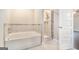 Bathroom featuring a soaking tub and glass enclosed shower at 8041 Louis Dr, Locust Grove, GA 30248
