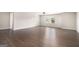 Large bedroom featuring wood flooring, natural light, and neutral paint, with a ceiling fan at 8041 Louis Dr, Locust Grove, GA 30248