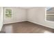 This bedroom is bright, spacious, and features hardwood flooring at 8041 Louis Dr, Locust Grove, GA 30248