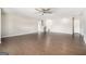 Large bonus room with hardwood floors, neutral paint, and multiple doors at 8041 Louis Dr, Locust Grove, GA 30248