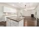 Kitchen island with granite countertops overlooks living room with fireplace and hardwood floors at 8041 Louis Dr, Locust Grove, GA 30248