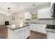 Bright, modern kitchen featuring granite countertops, stainless steel appliances, and a center island with wooden floors at 8041 Louis Dr, Locust Grove, GA 30248