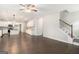 Hardwood floors, a ceiling fan, and an adjacent kitchen enhance this bright and open living space at 8041 Louis Dr, Locust Grove, GA 30248