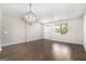 A spacious living room with wood floors and a geometric light fixture offers ample natural light at 8041 Louis Dr, Locust Grove, GA 30248