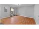 Neutral bedroom featuring a window for natural light and wood-look floors at 465 Haynie Rd, Moreland, GA 30259