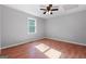 Comfortable bedroom with wood-look floors, neutral paint, and natural light at 465 Haynie Rd, Moreland, GA 30259