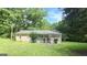 Charming single-story home featuring a welcoming front porch and a well-maintained lawn at 465 Haynie Rd, Moreland, GA 30259