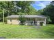 Charming single-story home featuring a welcoming front porch and a well-maintained green lawn at 465 Haynie Rd, Moreland, GA 30259