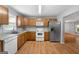 Efficient kitchen layout featuring wood cabinets, white appliances, and a bright window for natural light at 465 Haynie Rd, Moreland, GA 30259