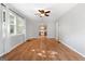 Spacious living room with wood floors, a ceiling fan, and natural light at 465 Haynie Rd, Moreland, GA 30259