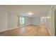 Open-concept living room with ample natural light and wood-look floors creating a welcoming atmosphere at 465 Haynie Rd, Moreland, GA 30259