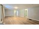 Bright, spacious living room with neutral walls and wood-look flooring, ready for personalized touches at 465 Haynie Rd, Moreland, GA 30259