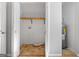 Bright utility closet with water heater and overhead wooden shelving unit for efficient storage space at 465 Haynie Rd, Moreland, GA 30259